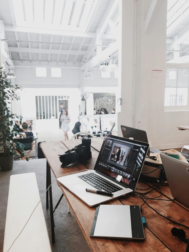 pexels photo 699459 699459 A bright, modern workspace featuring laptops, a camera, and a drawing tablet in an indoor office.